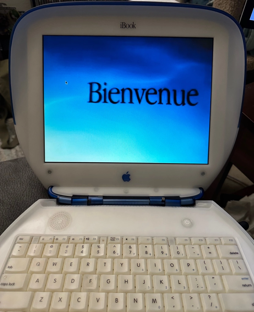 My Indigo iBook G3 Clamshell, showing the introduction video from Mac OS X “Puma” 10.1.